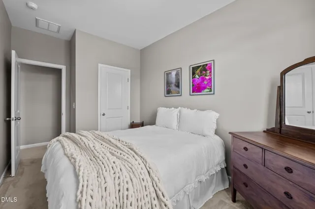 a bedroom with a bed and a dresser