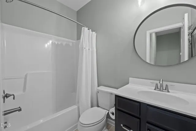 a bathroom with a sink vanity mirror and toilet