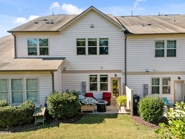 a view of a house with a yard and sitting area