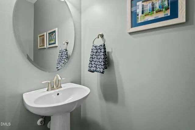 a bathroom with a sink a mirror and a toilet