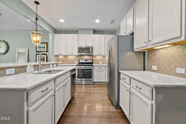 a kitchen with a sink stove and refrigerator