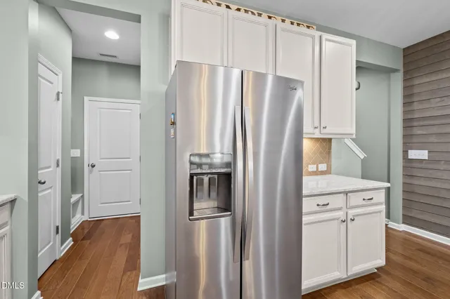 a kitchen with stainless steel appliances a refrigerator and a stove top oven