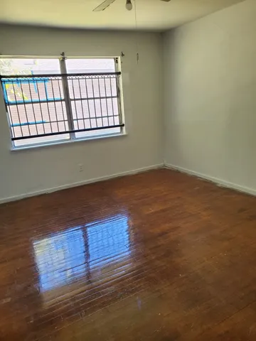a view of wooden floor and brick walls