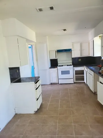 a kitchen with a stove and a refrigerator