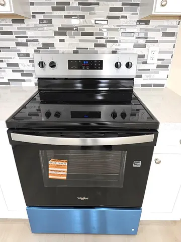 a view of a hallway with wooden floor and entryway
