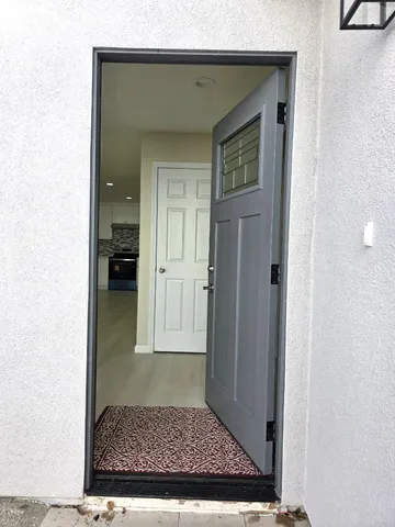 a view of an empty room with a fireplace and a window