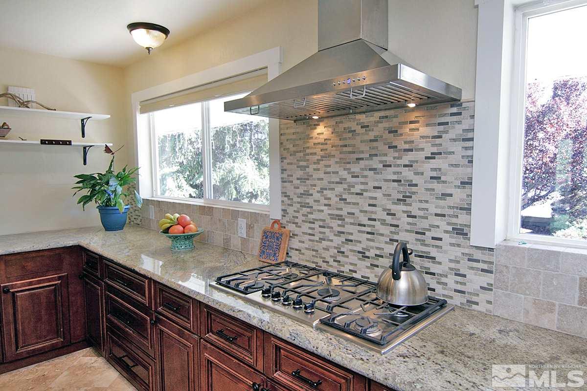 1301 Belford Road Reno, NV 89509 - Photo 8 of 25 a kitchen with granite countertop a stove and a shower