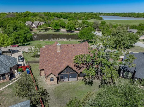 an aerial view of a house with garden space and lake view
