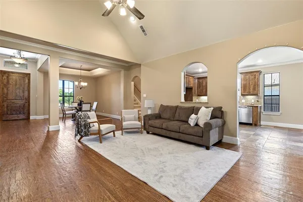 a living room with furniture and a wooden floor
