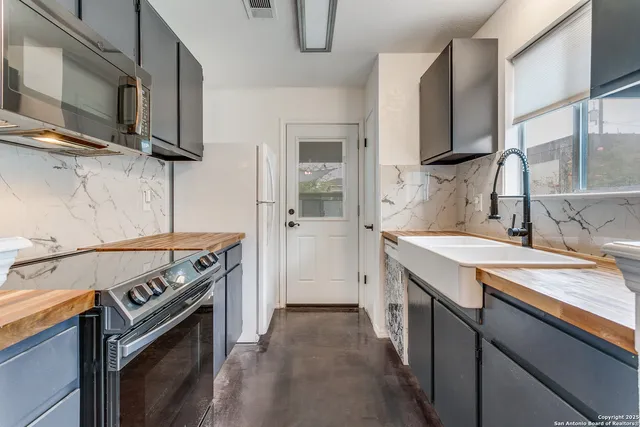 a kitchen with stainless steel appliances granite countertop a stove and a sink