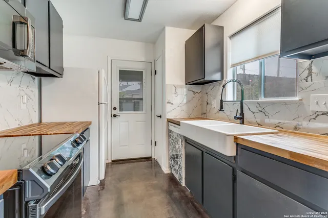 a utility room with a sink dryer and washer