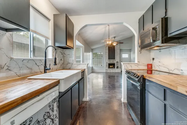 a kitchen with stainless steel appliances granite countertop a sink and stove