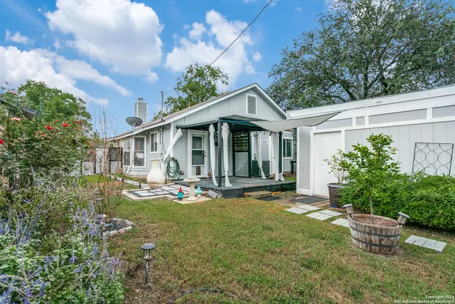 a view of a house with pool and garden
