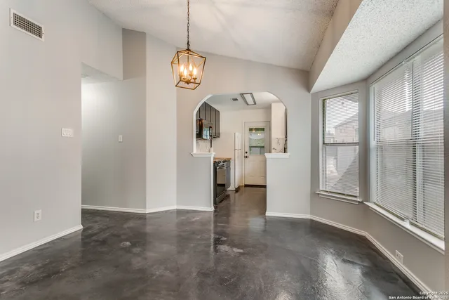an empty room with wooden floor and mirror