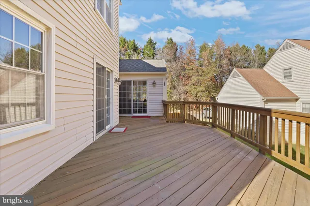 a view of a house with wooden deck