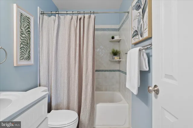 a bathroom with a toilet a sink and shower
