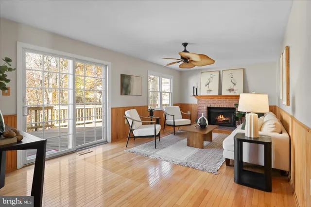 a living room with furniture a fireplace and a large window