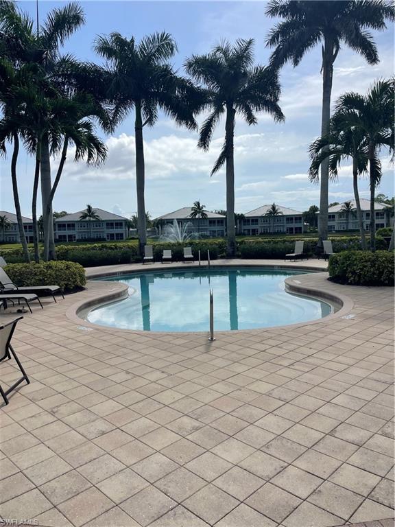 7168 Lemuria Circle, Unit 1701 Naples, FL 34109 - Photo 24 of 30 Community pool with a patio