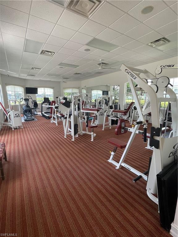 7168 Lemuria Circle, Unit 1701 Naples, FL 34109 - Photo 26 of 30 Gym with a paneled ceiling and a ceiling fan