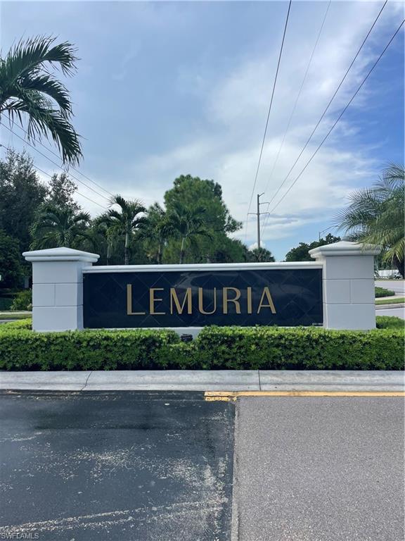 7168 Lemuria Circle, Unit 1701 Naples, FL 34109 - Photo 30 of 30 Community sign featuring uncovered parking