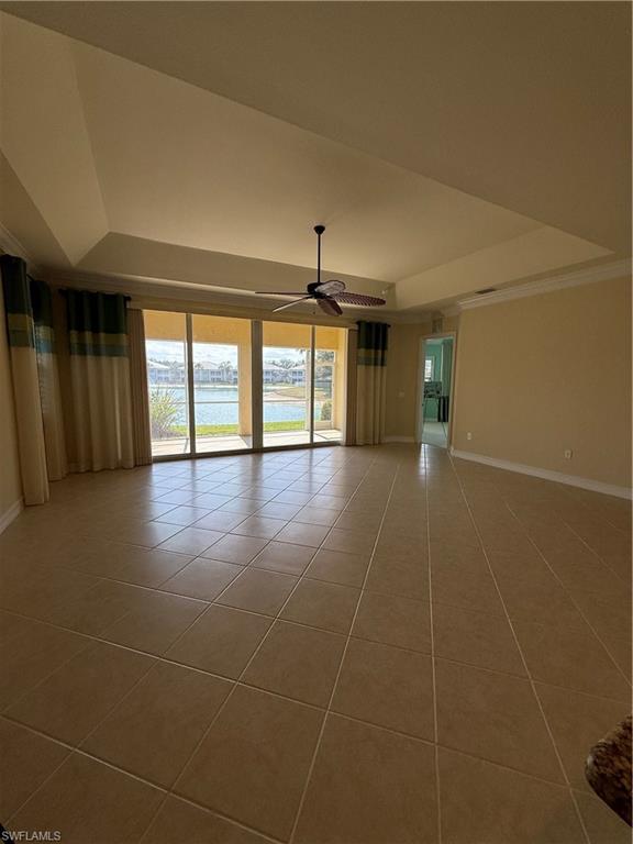 7168 Lemuria Circle, Unit 1701 Naples, FL 34109 - Photo 6 of 30 Tiled spare room with a raised ceiling, a water view, ceiling fan, and plenty of natural light