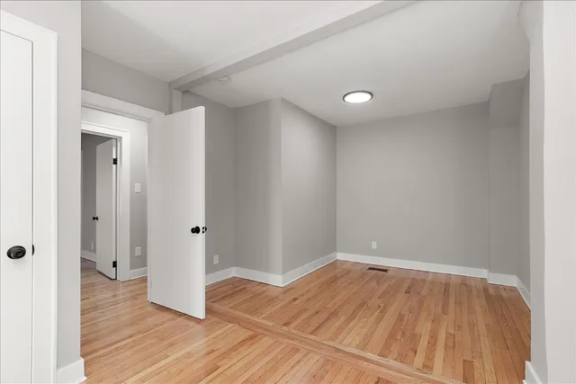 a view of a room with wooden floor and natural light