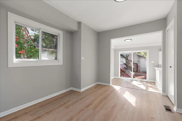 a view of a room with wooden floor and a window