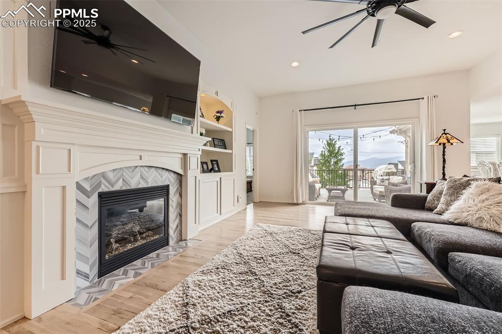 2513 Cinnabar Road Colorado Springs, CO 80921 - Photo 5 of 27 a living room with furniture a fireplace and a flat screen tv