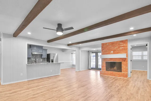 a view of a living room a kitchen and a fireplace