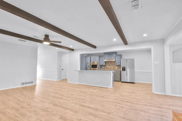 a view of a kitchen with a sink and cabinets