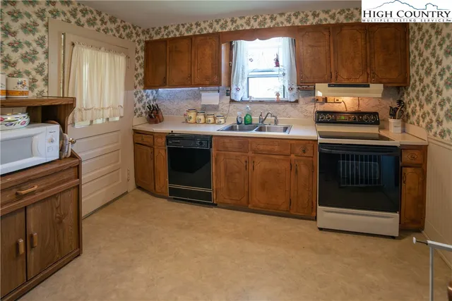 a kitchen with a sink stove and cabinets