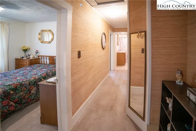 a bedroom with a bed and a mirror