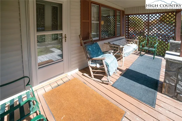 a view of a patio with table and chairs and wooden floor