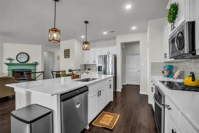 a kitchen with cabinets a sink and stainless steel appliances