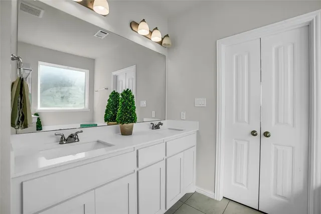 a bathroom with a double vanity sink and mirror