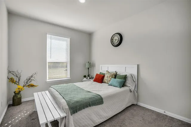 a bedroom with bed and a window