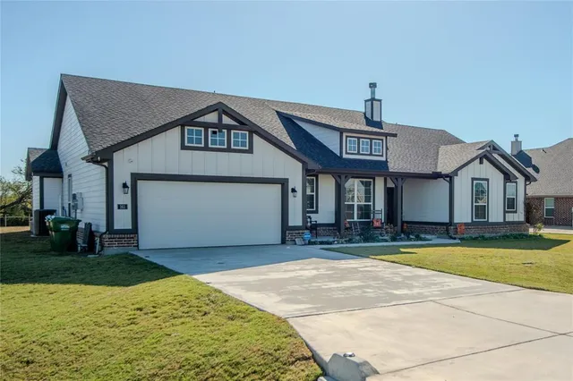 a view of a house with a yard and garage