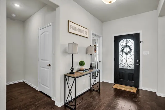 a view of an entryway with wooden floor