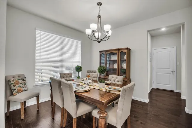 a view of a dining room with furniture wooden floor and chandelier