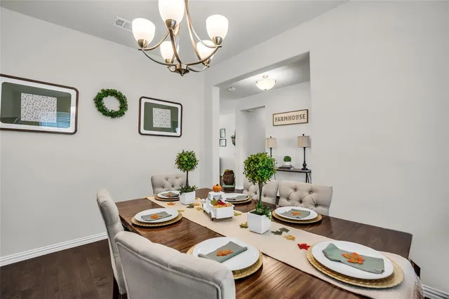 a view of a dining room with furniture a rug and wooden floor