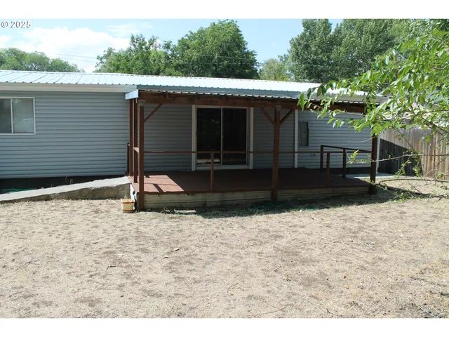 a backyard of a house with wooden fence