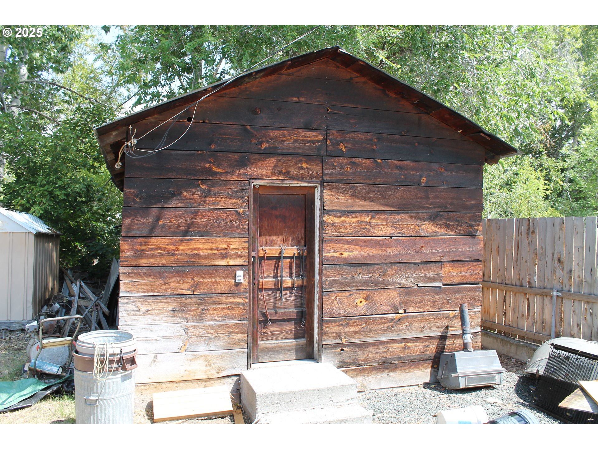 210 Mountain Boulevard Mount Vernon, OR 97865 - Photo 20 of 23 a backyard of a house with wooden fence and large trees