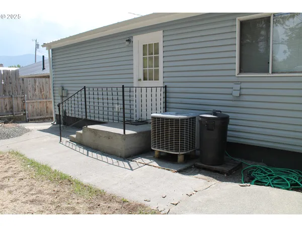 a view of a house with a bench in patio