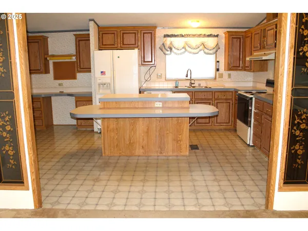 a dining room with a sink a counter top space and appliances