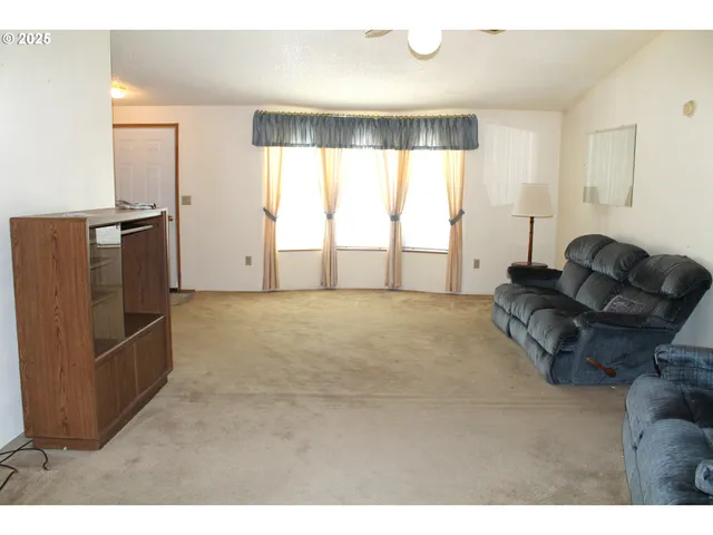 a living room with furniture window and a wooden floor