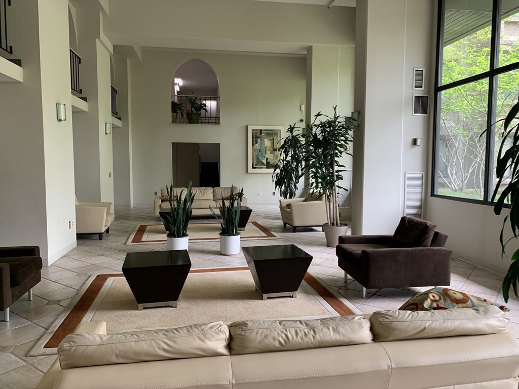 1731 Beacon Street, Unit 1213 Brookline, MA 02445 - Photo 16 of 29 a living room with furniture and a fireplace