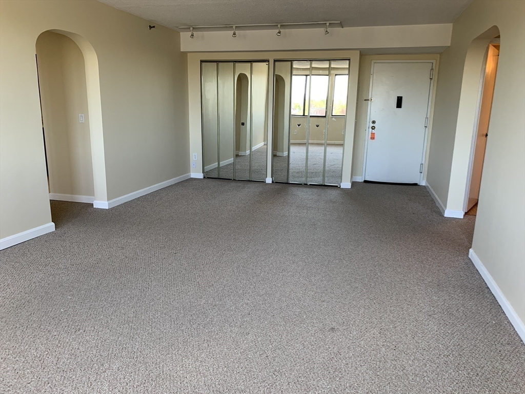 1731 Beacon Street, Unit 1213 Brookline, MA 02445 - Photo 19 of 29 a view of an empty room and window