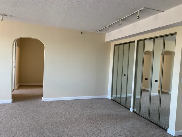 a view of a hallway with wooden walls