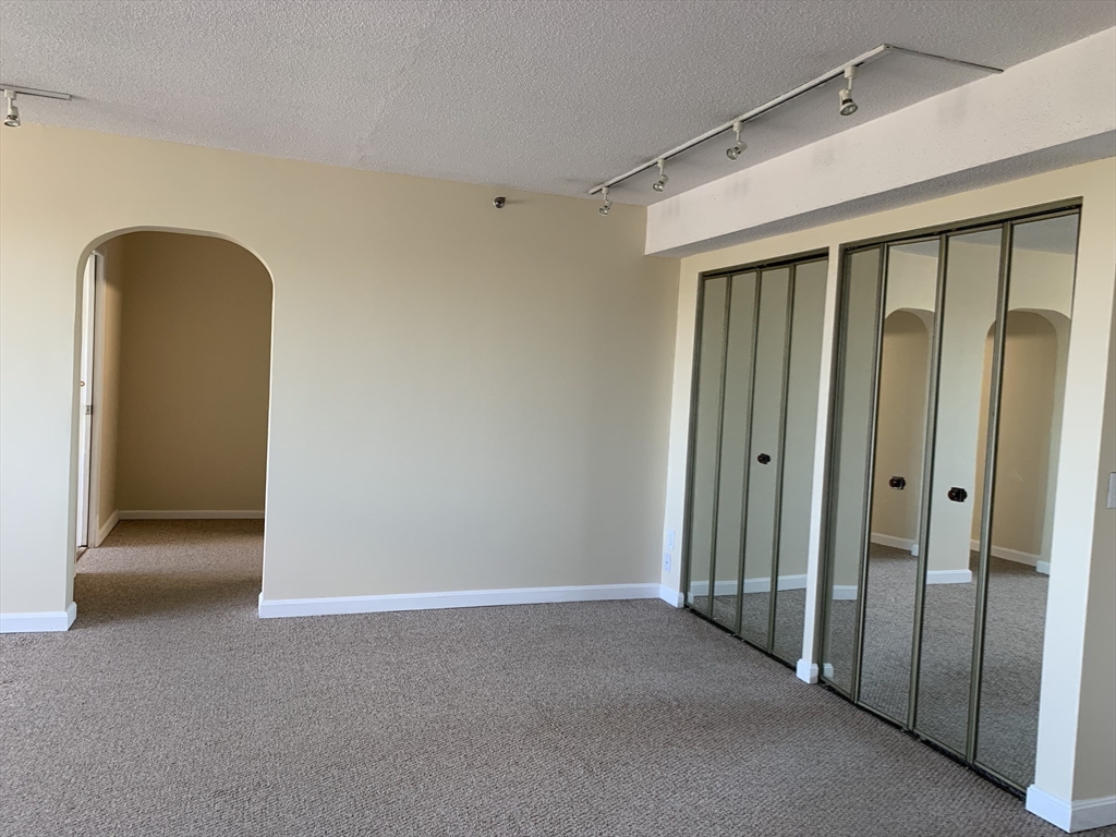 1731 Beacon Street, Unit 1213 Brookline, MA 02445 - Photo 20 of 29 a view of a hallway with wooden walls