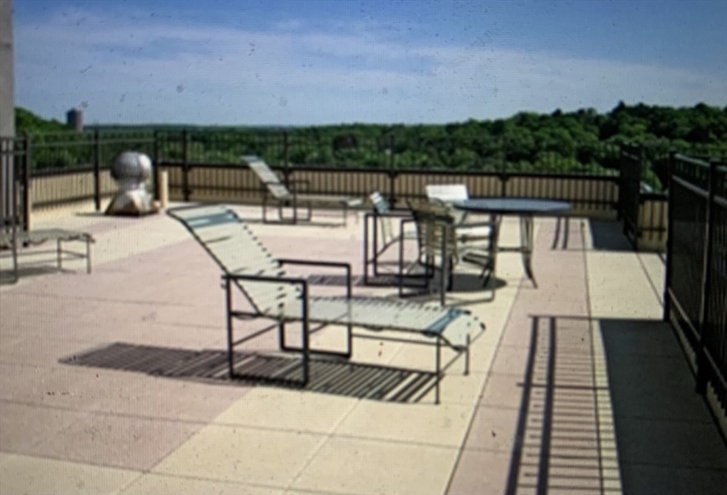 1731 Beacon Street, Unit 1213 Brookline, MA 02445 - Photo 2 of 29 a terrace with outdoor seating and city view